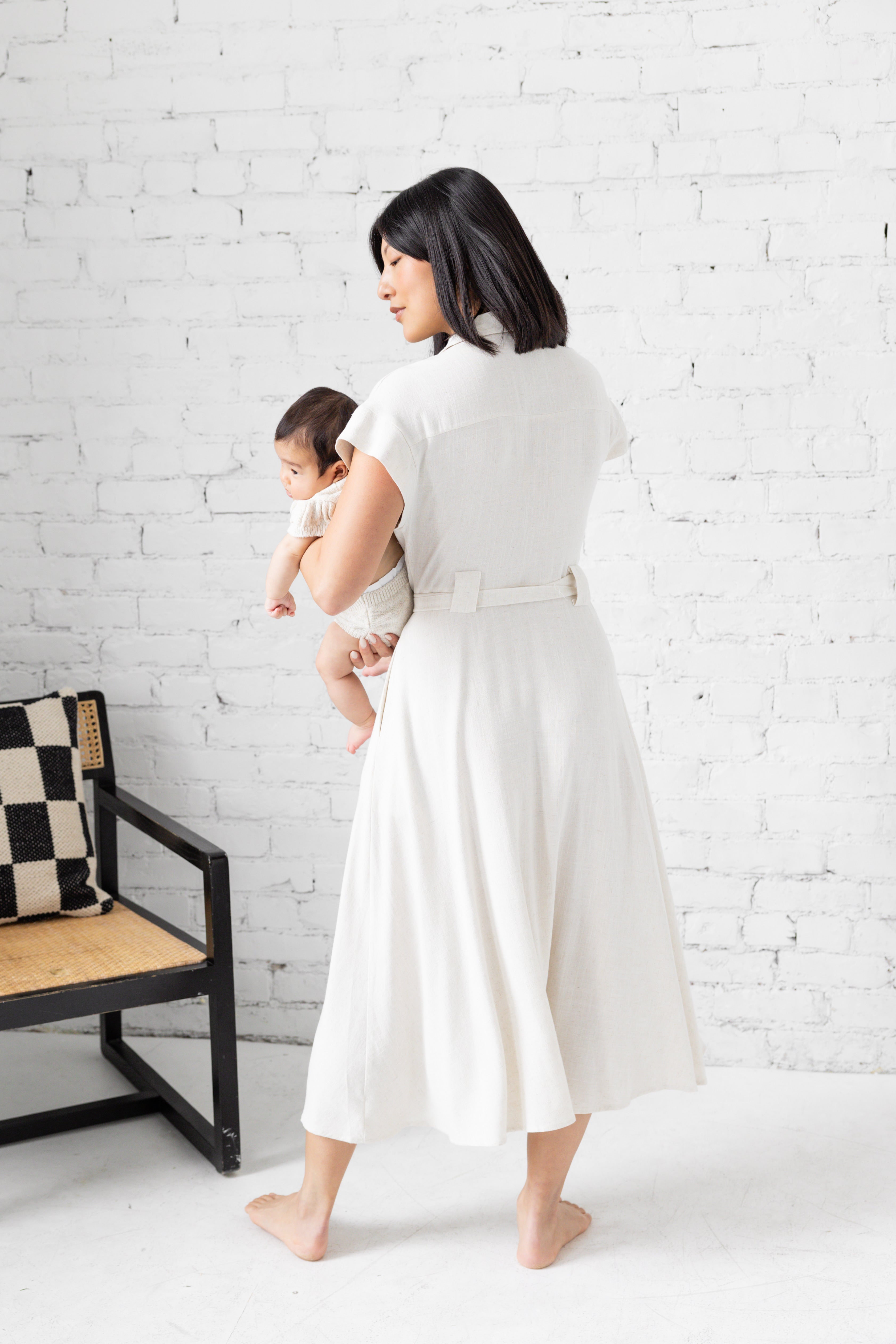 Model is wearing midi collared dress with belt with her family.