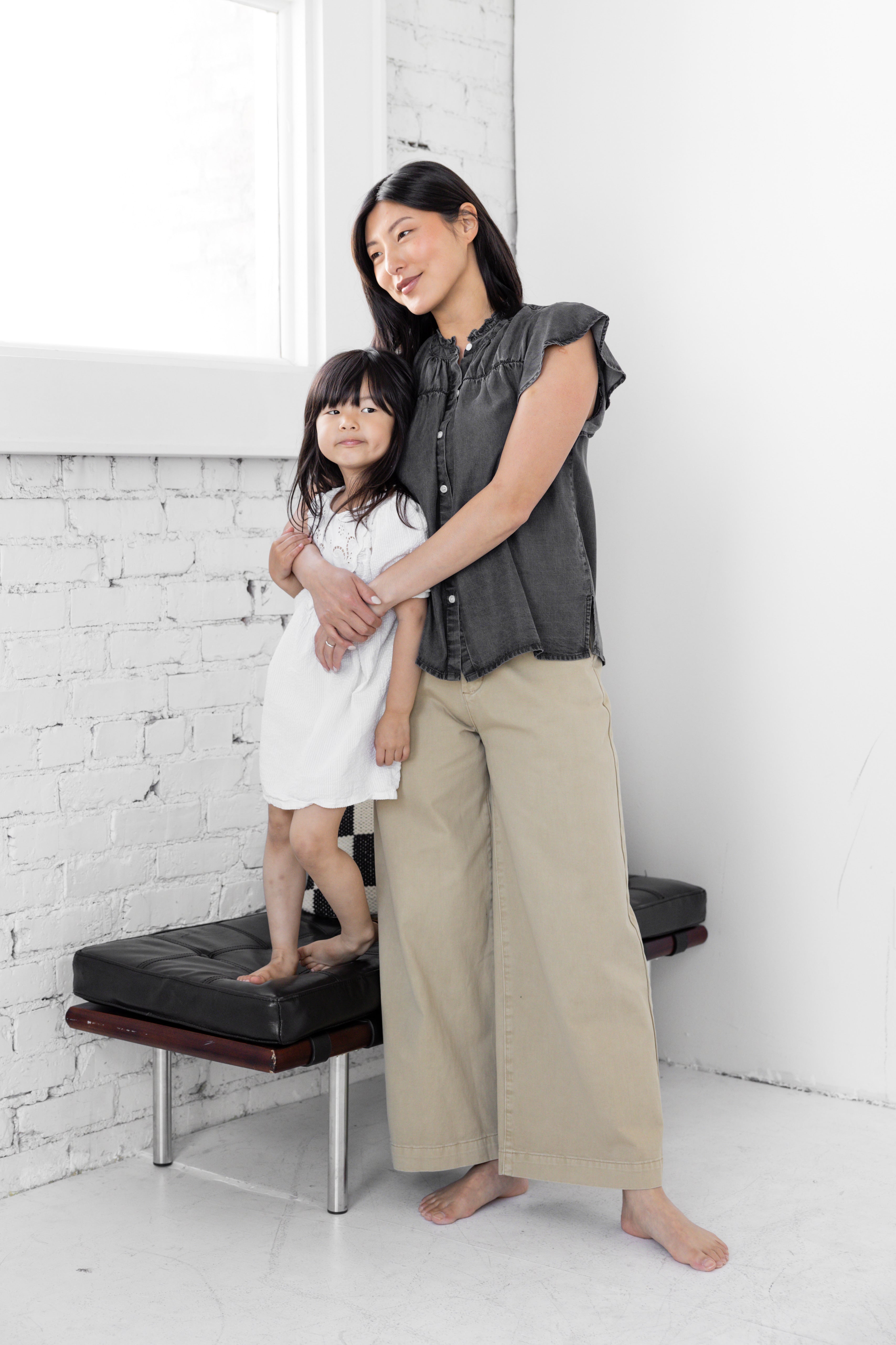 Model is wearing wide leg high rise trousers.