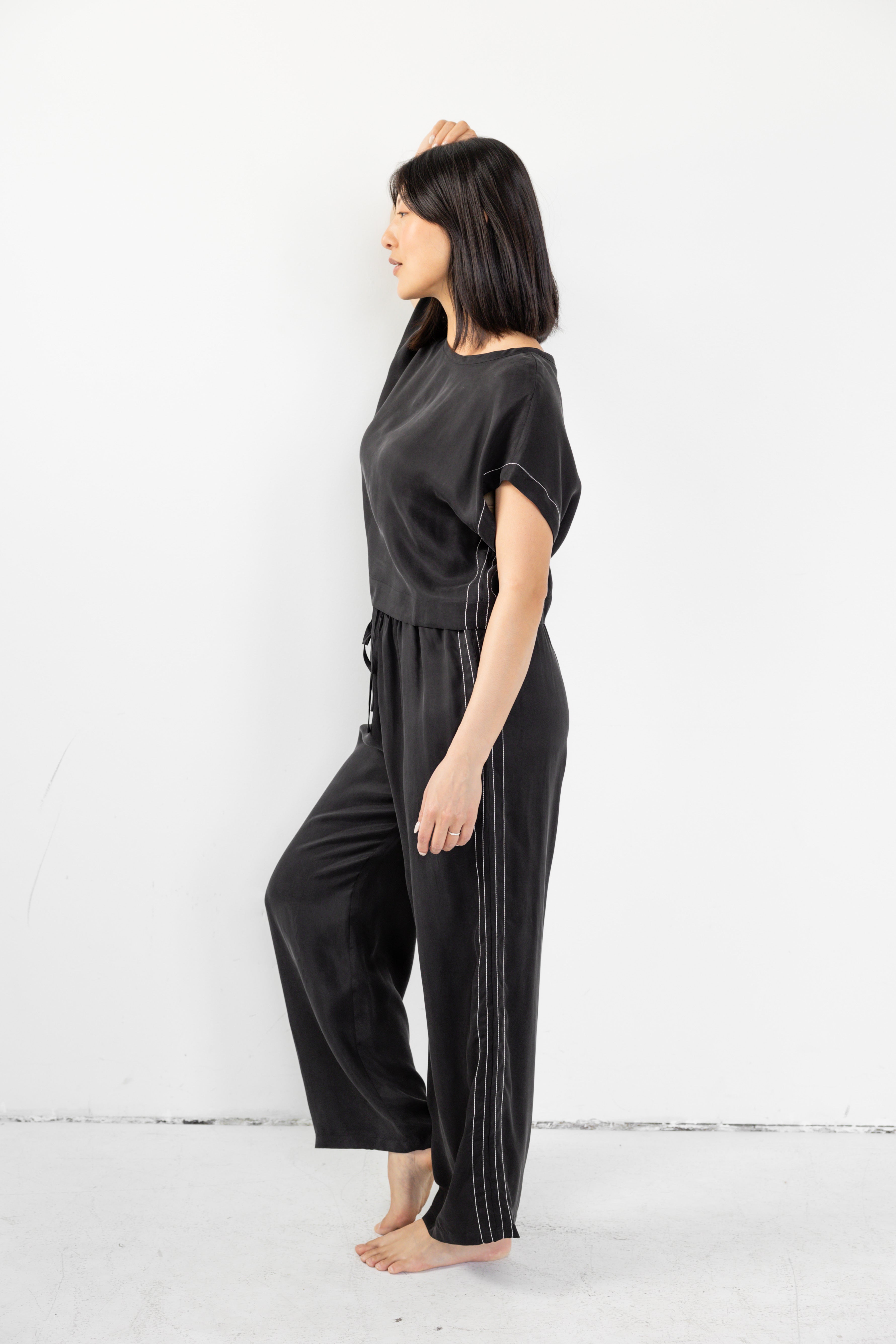 Model is wearing matching lounge set with cinched waist and boxy tee.