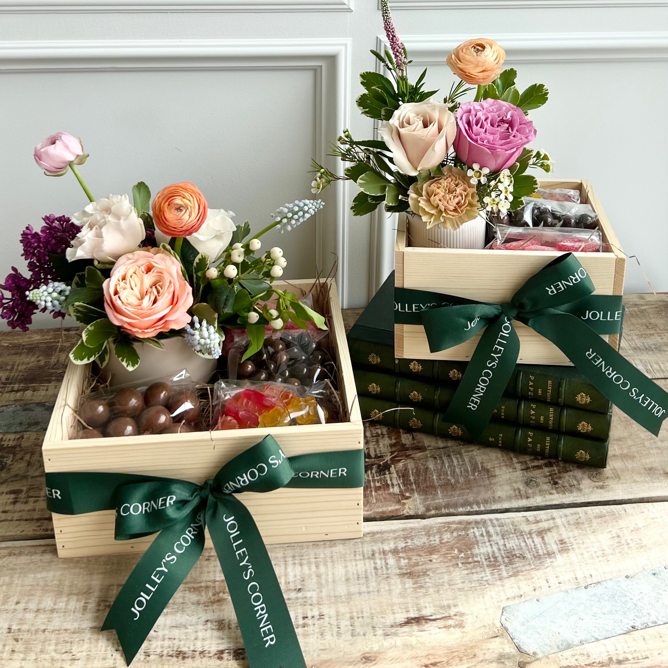 Gift baskets with floral arrangements and candy.