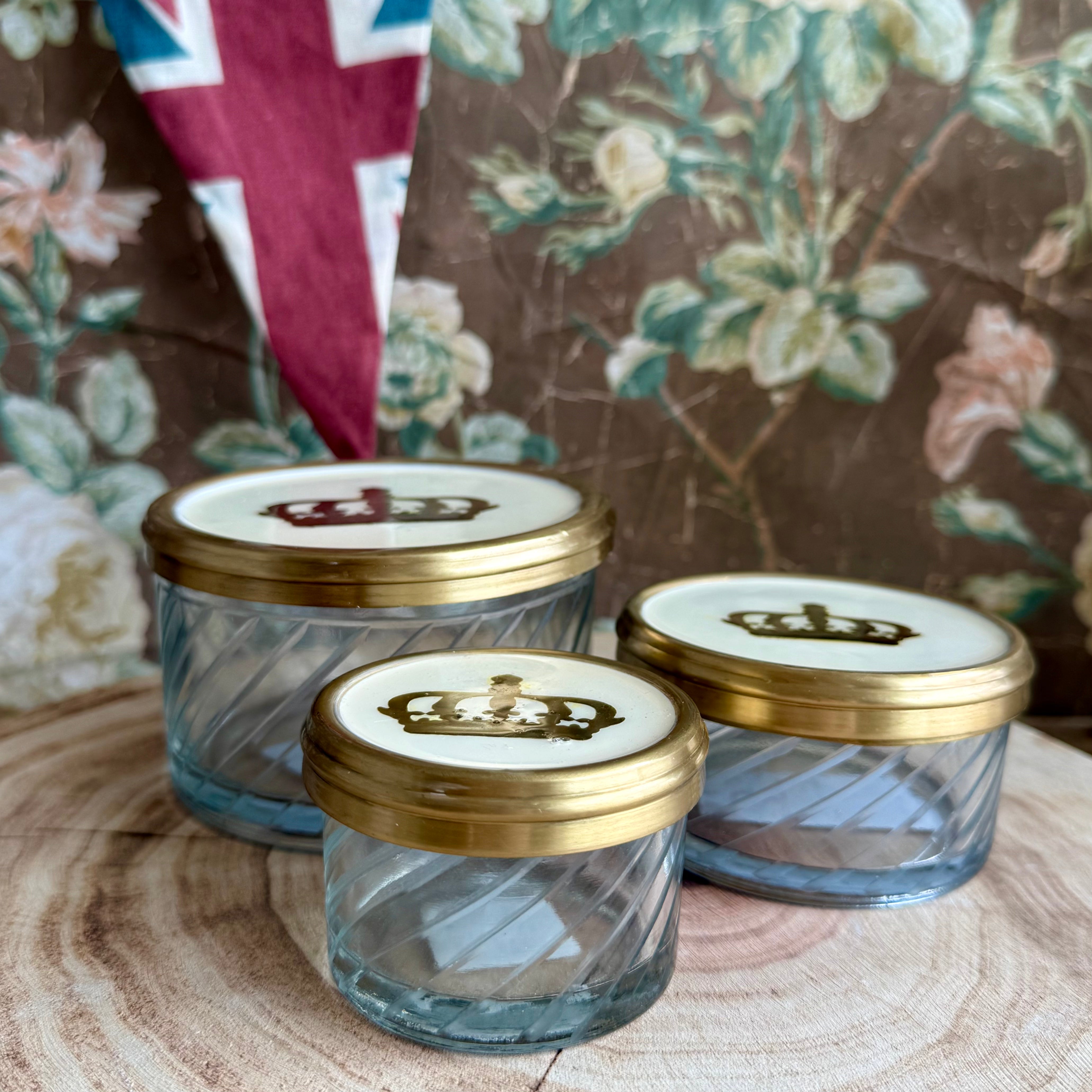 Product shoot of gold and glass crown jar.