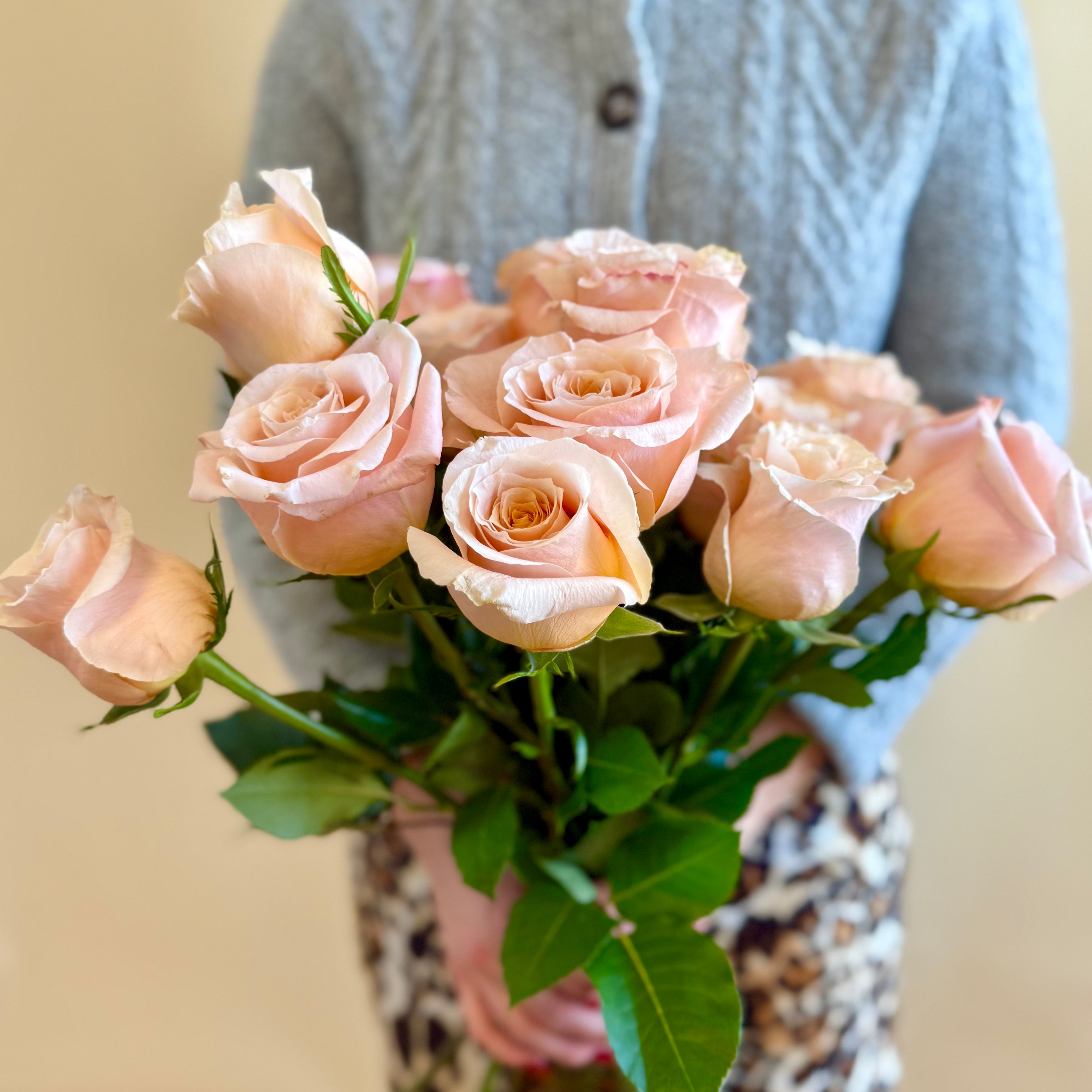 Product shoot of a dozen peach roses.