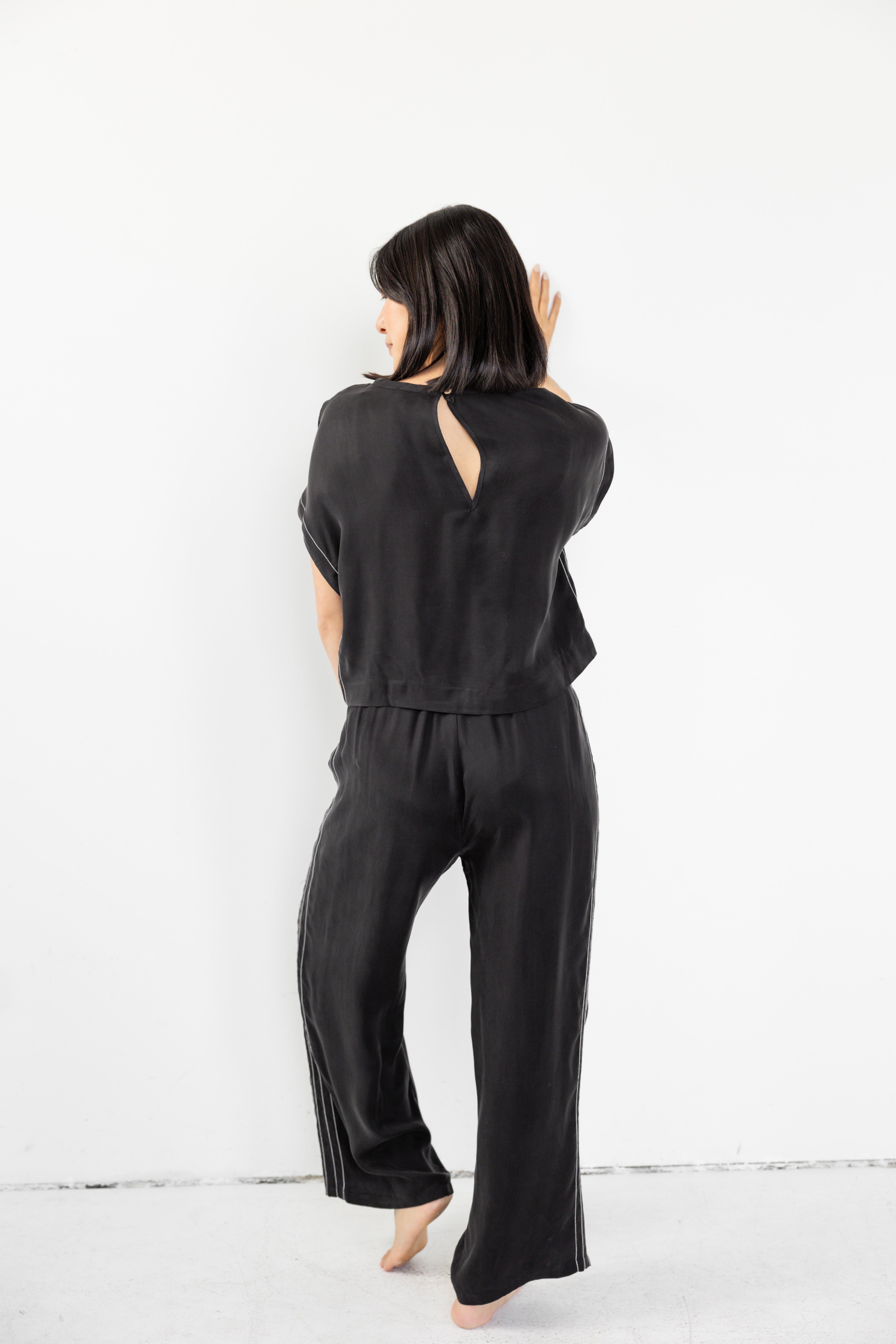 Model is wearing matching lounge set with cinched waist and boxy tee.