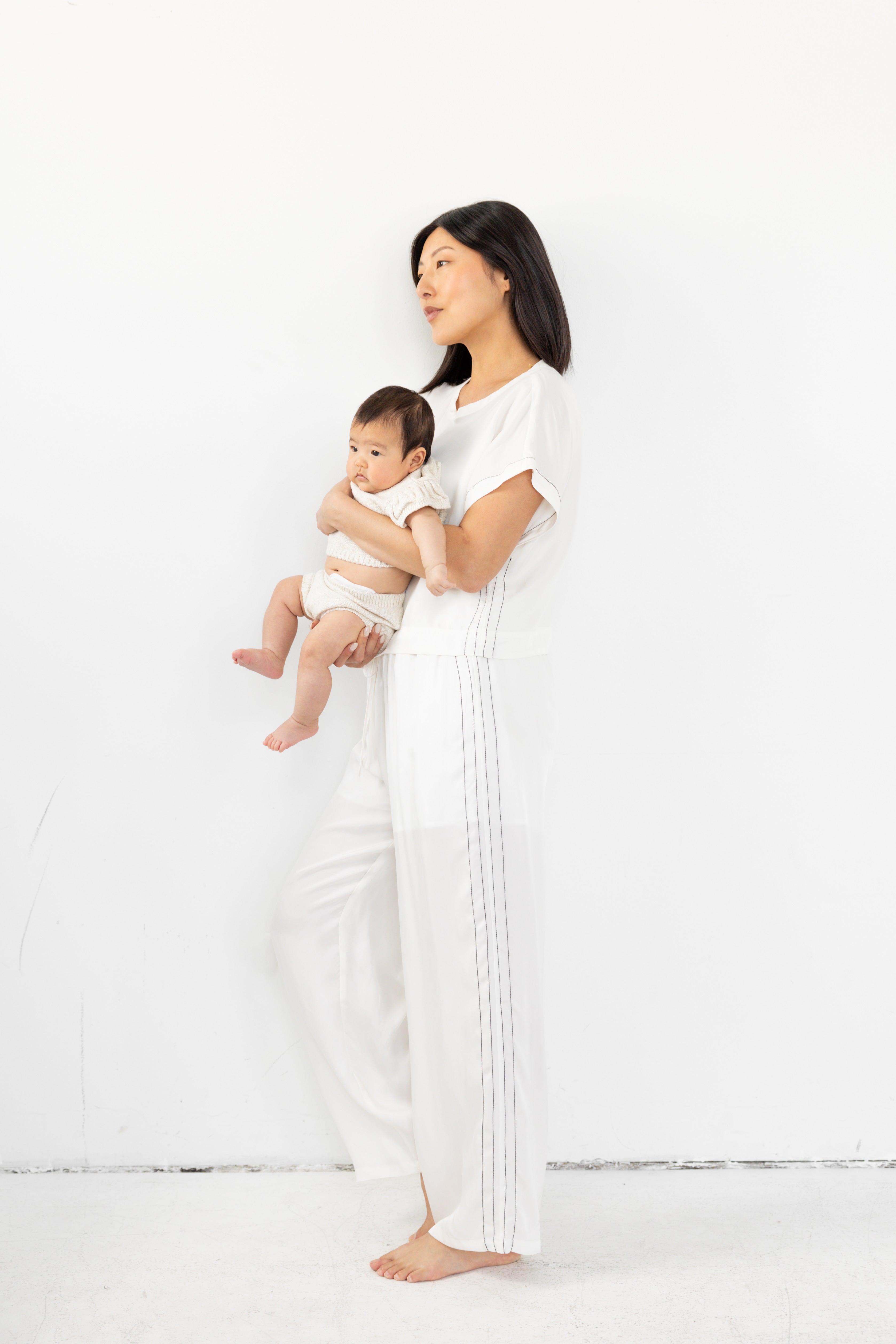 Model is wearing matching lounge set with cinched waist and boxy tee.