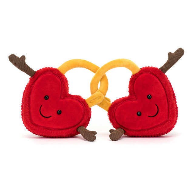 Plush toy heart lockets interconnected with faces and hands