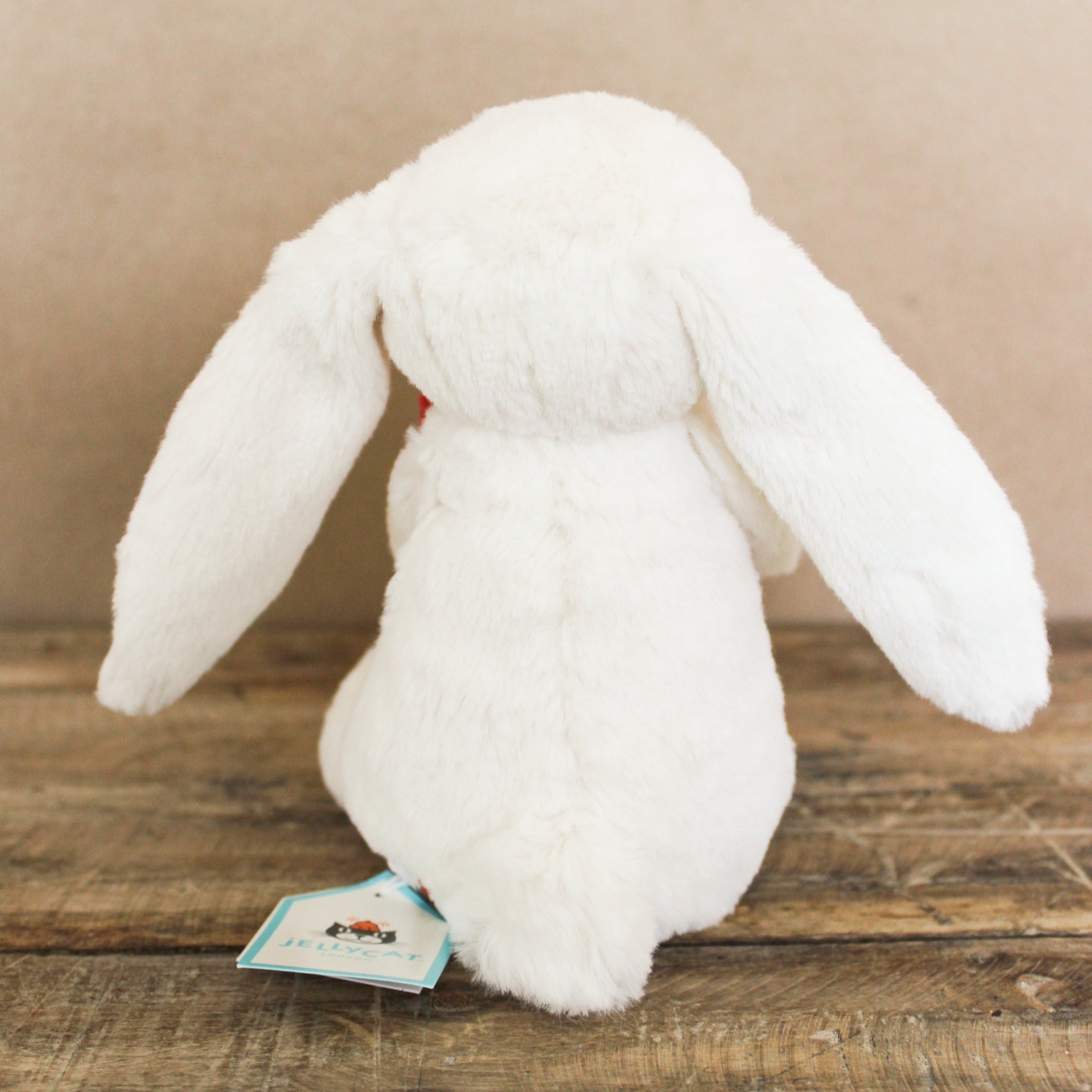 Stuffed bunny with floppy ears and holding a red heart