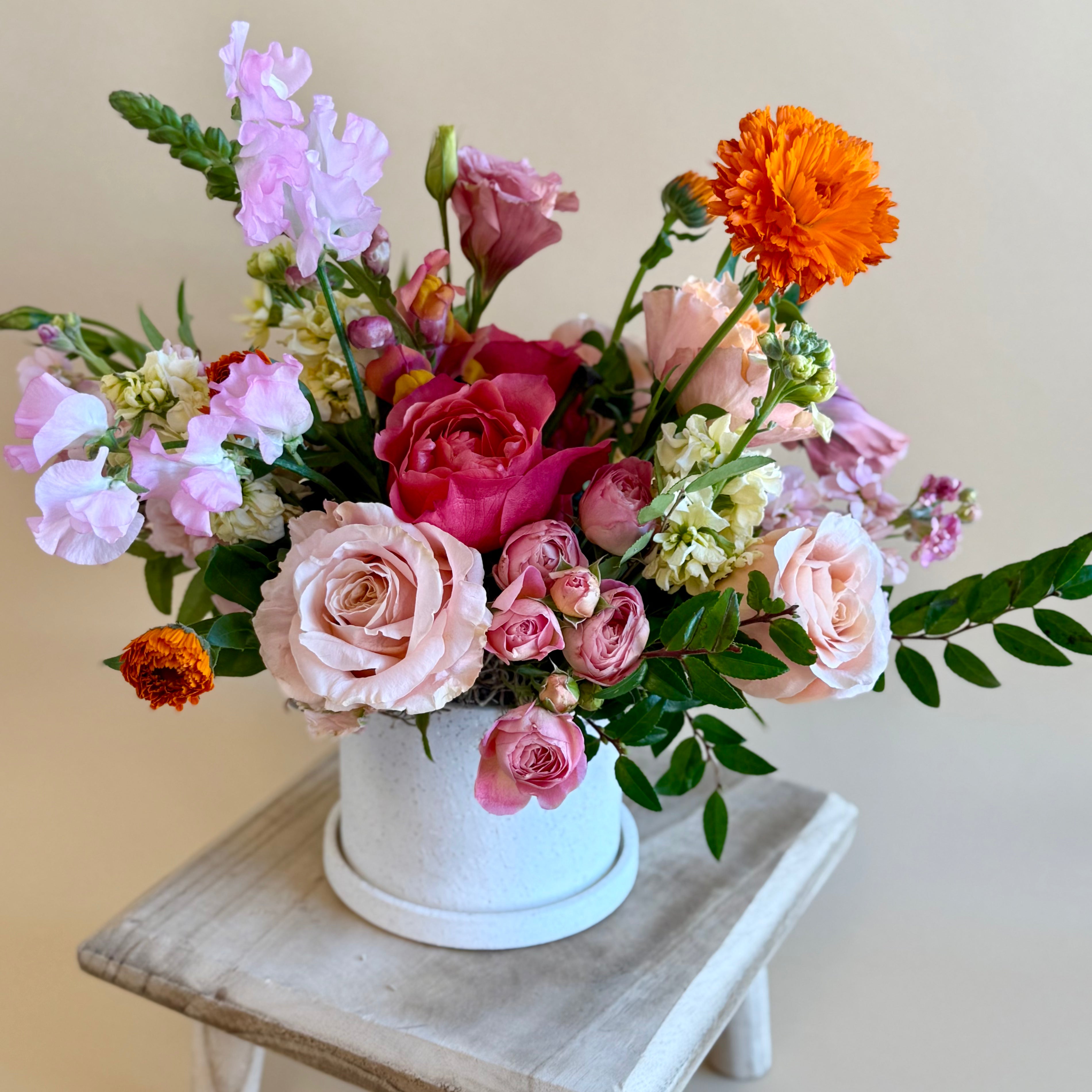 Bright pink and orange floral vase arrangement 