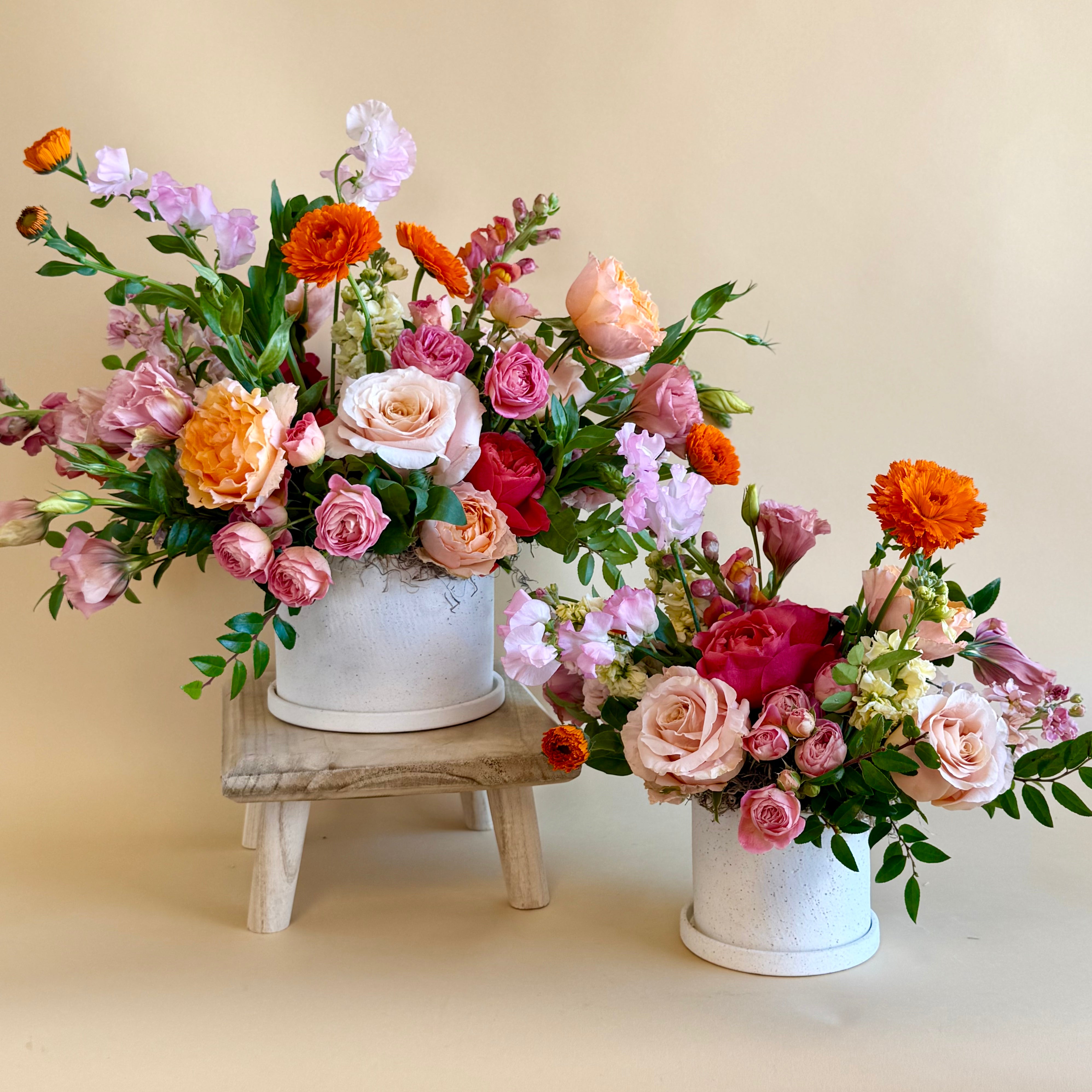 Bright pink and orange floral vase arrangement 