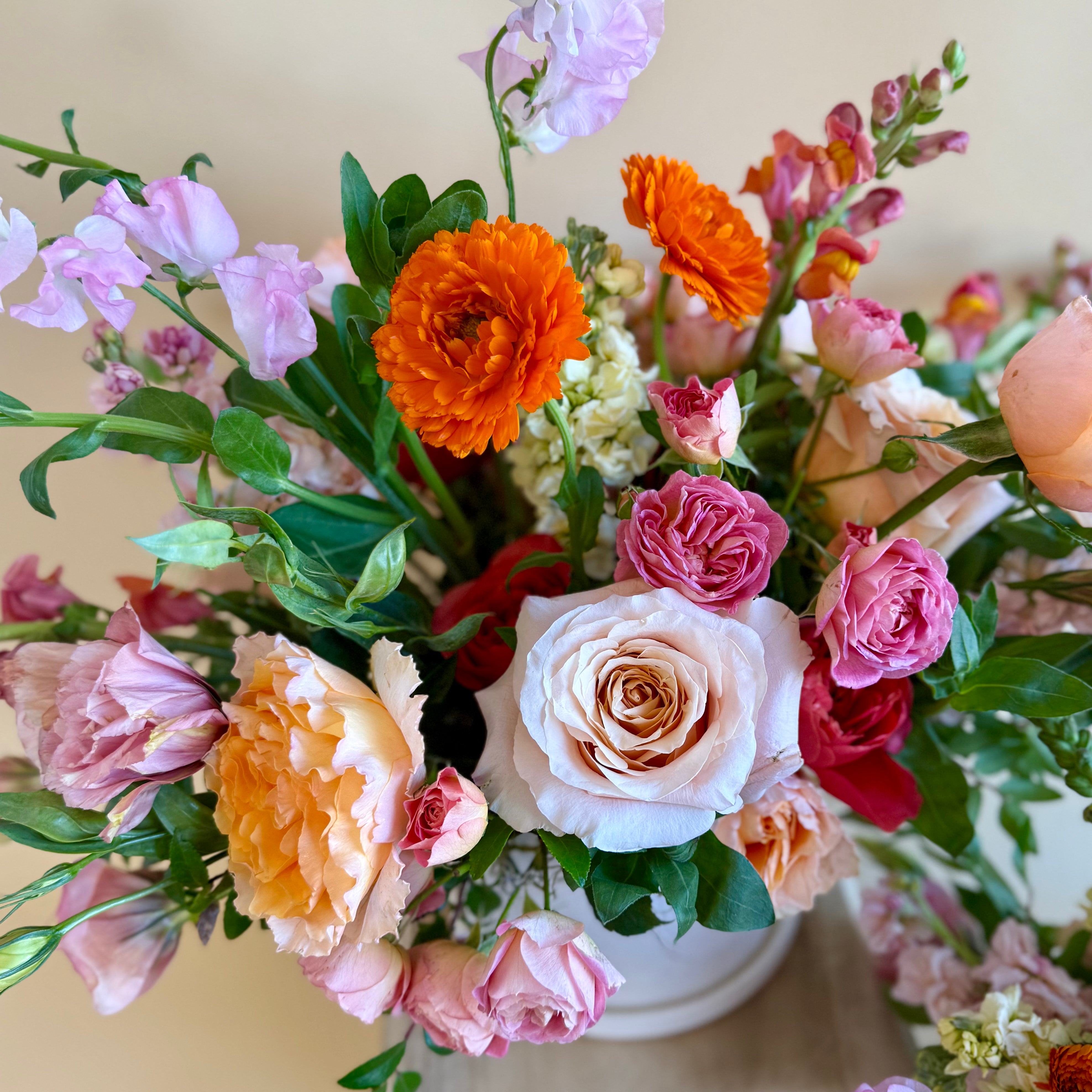 Bright pink and orange floral vase arrangement 