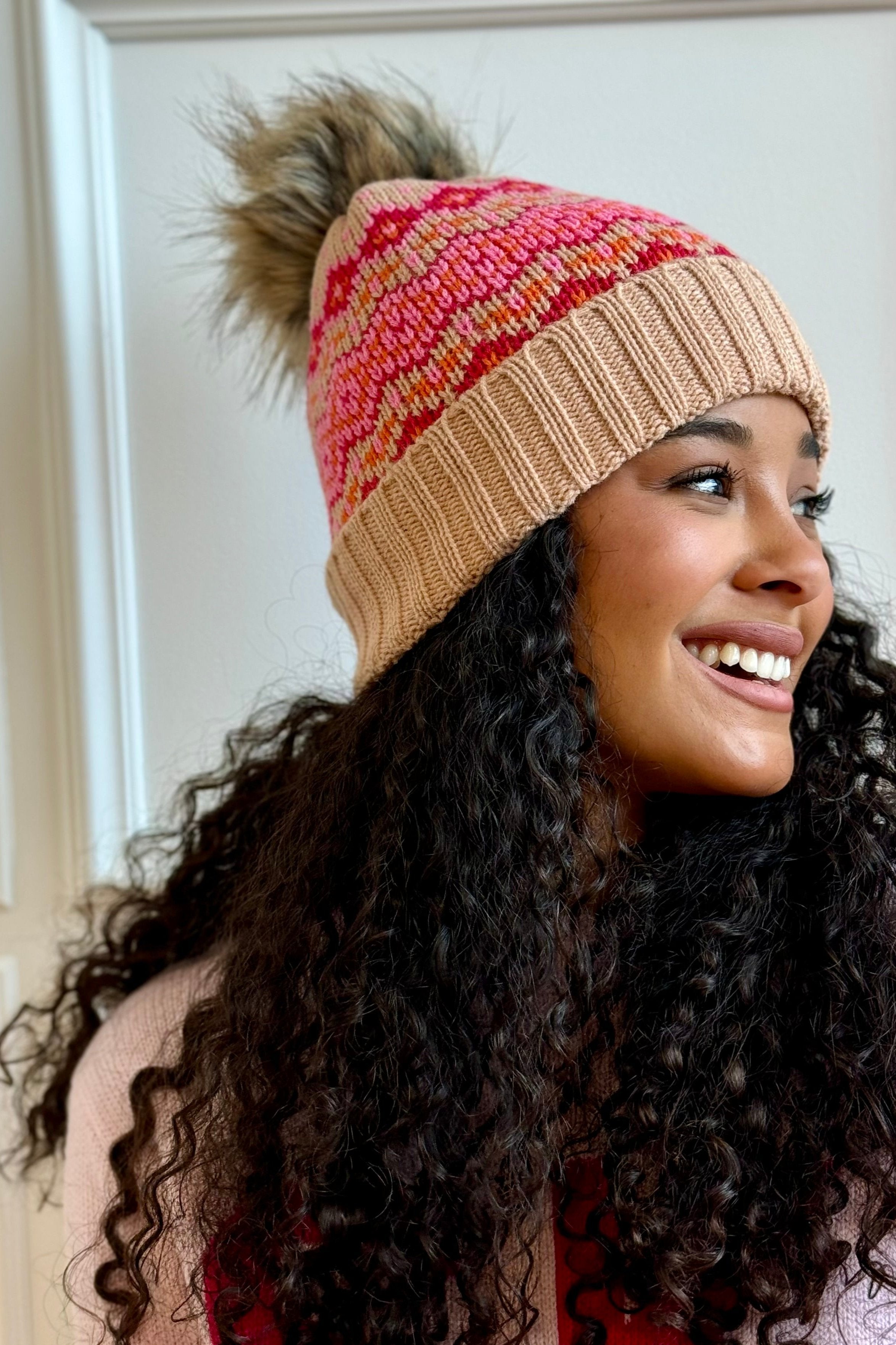 Woman looking to the side with knit beanie on.