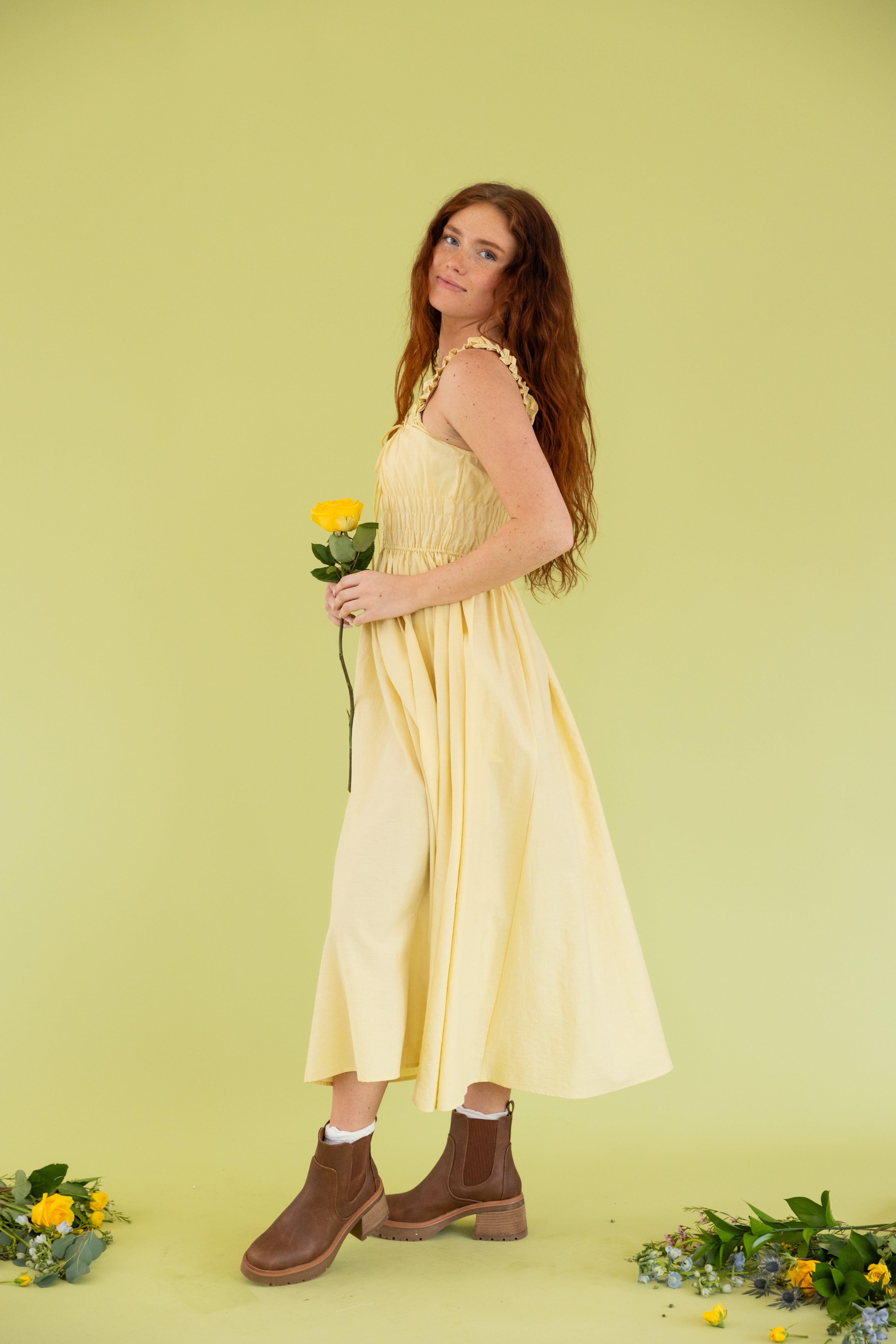 Model is wearing midi tank yellow dress