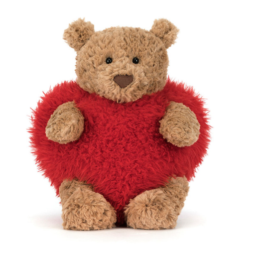 Stuffed animal bear wearing red heart 