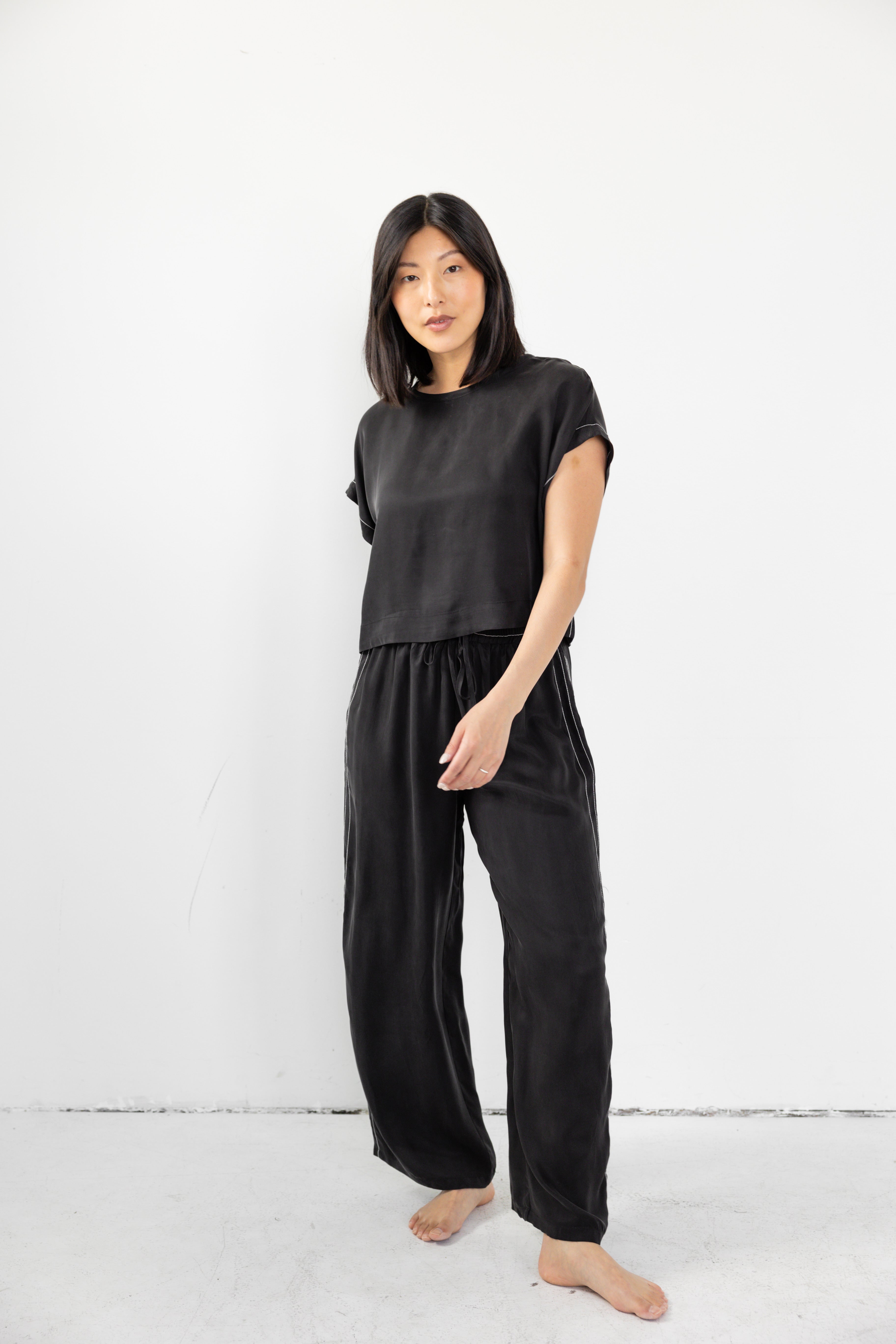 Model is wearing matching lounge set with cinched waist and boxy tee. 