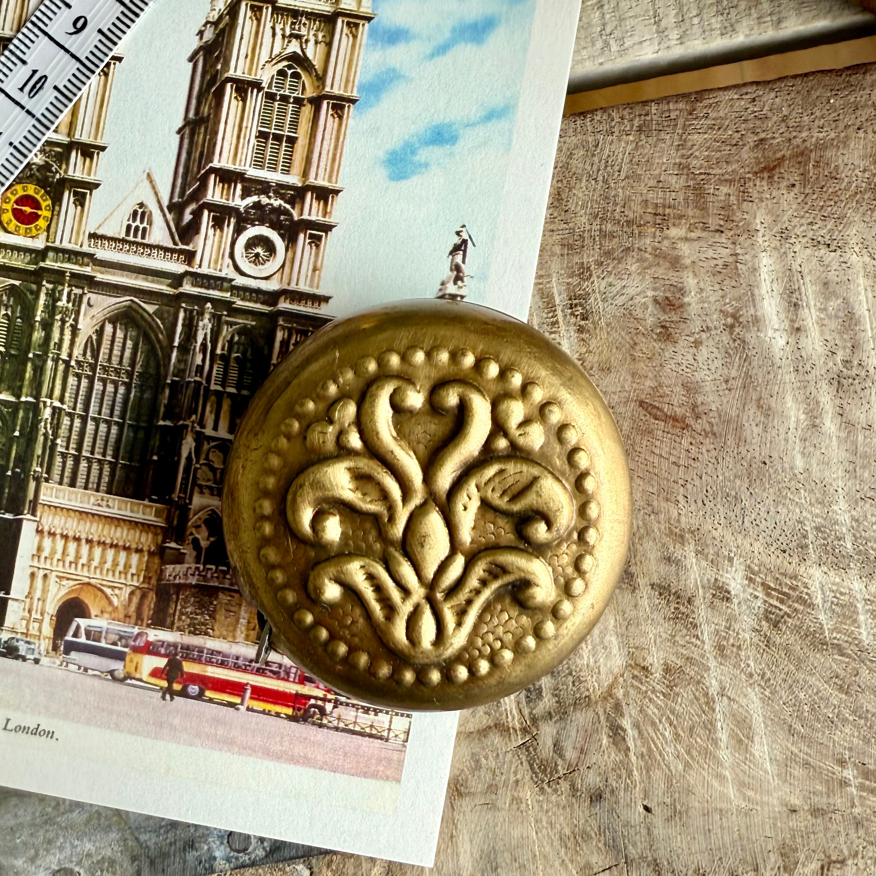 Product shoot of vintage brass measuring tapes.  