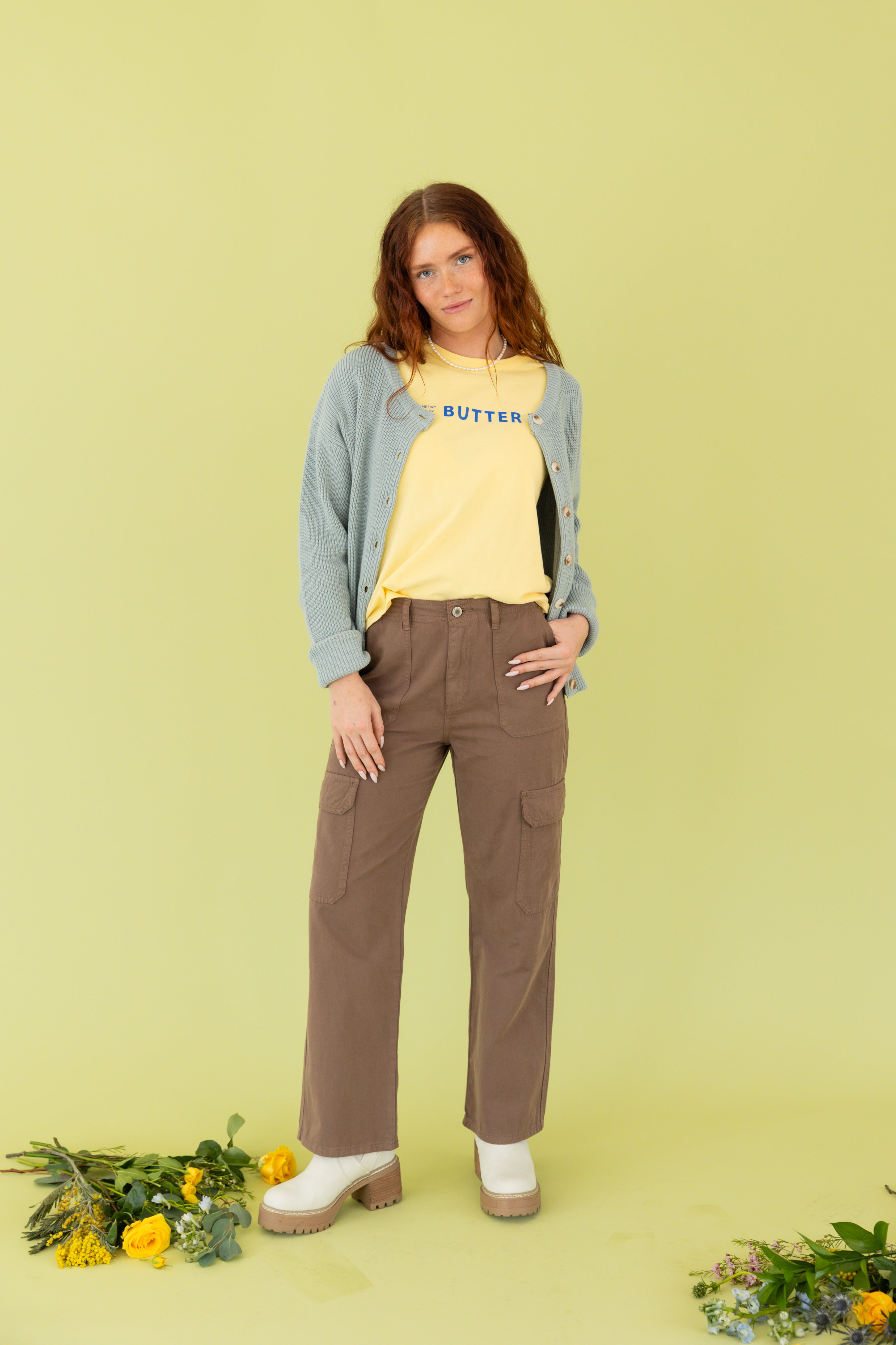 Model is wearing brown cargo pants. 