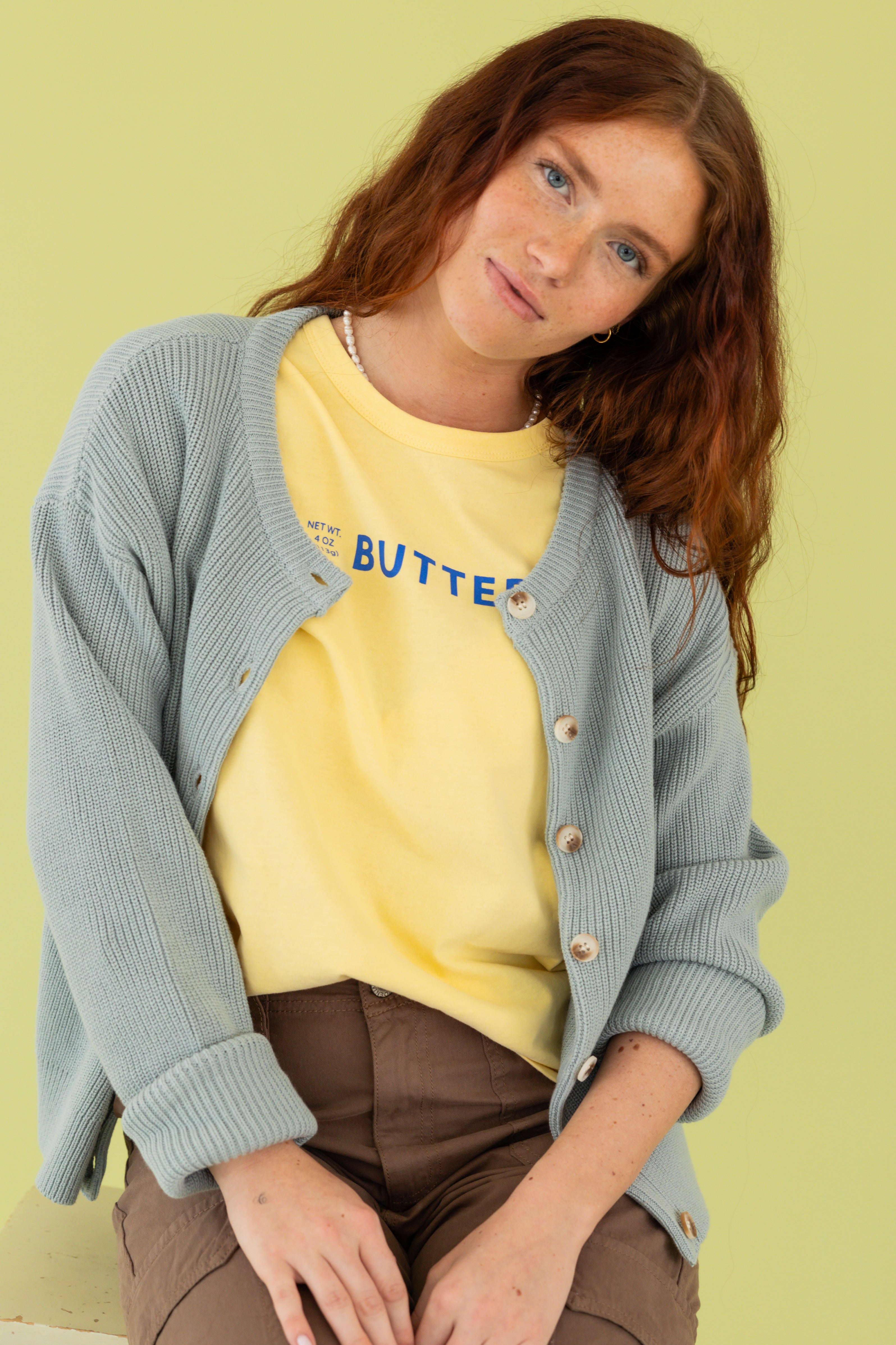 Model is wearing butter tee and brown pant 