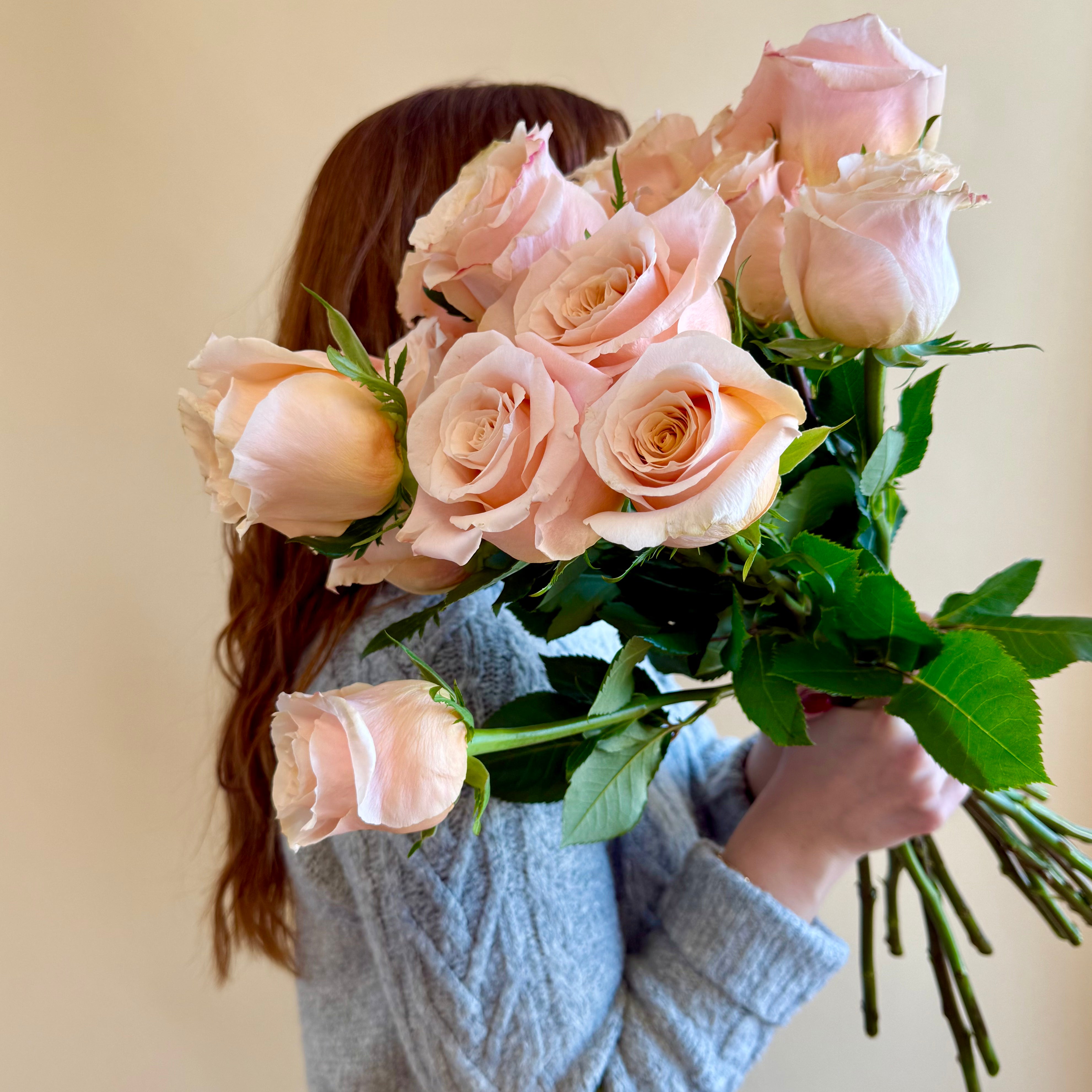 Product shoot of a dozen peach roses.