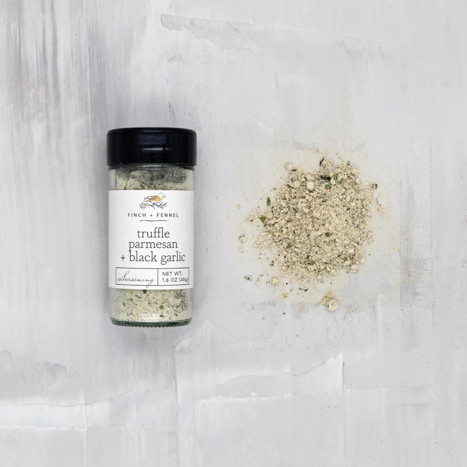 Product shoot of truffle parmesan and black garlic seasoning.