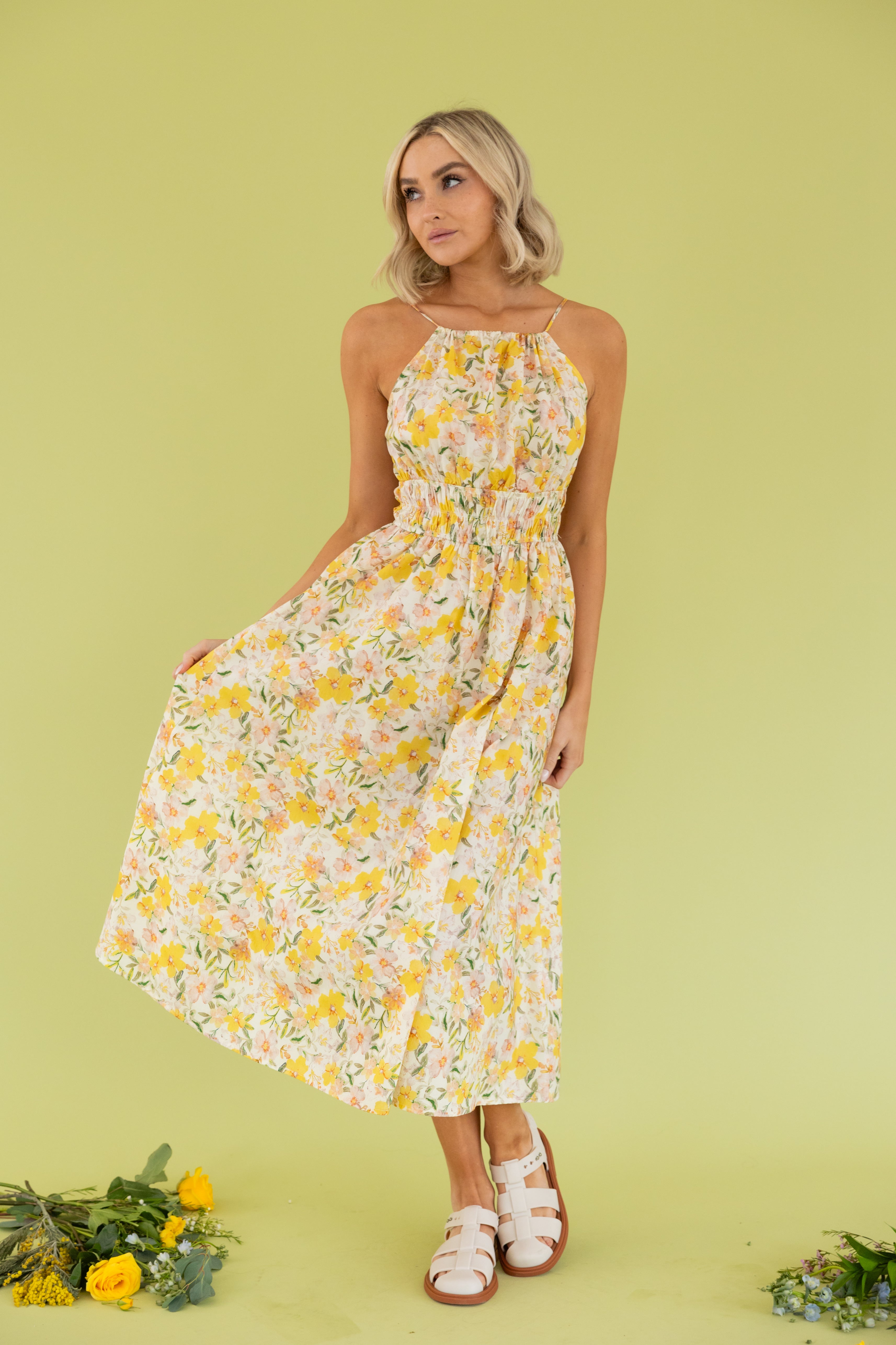 Model is wearing a floral halter maxi dress.