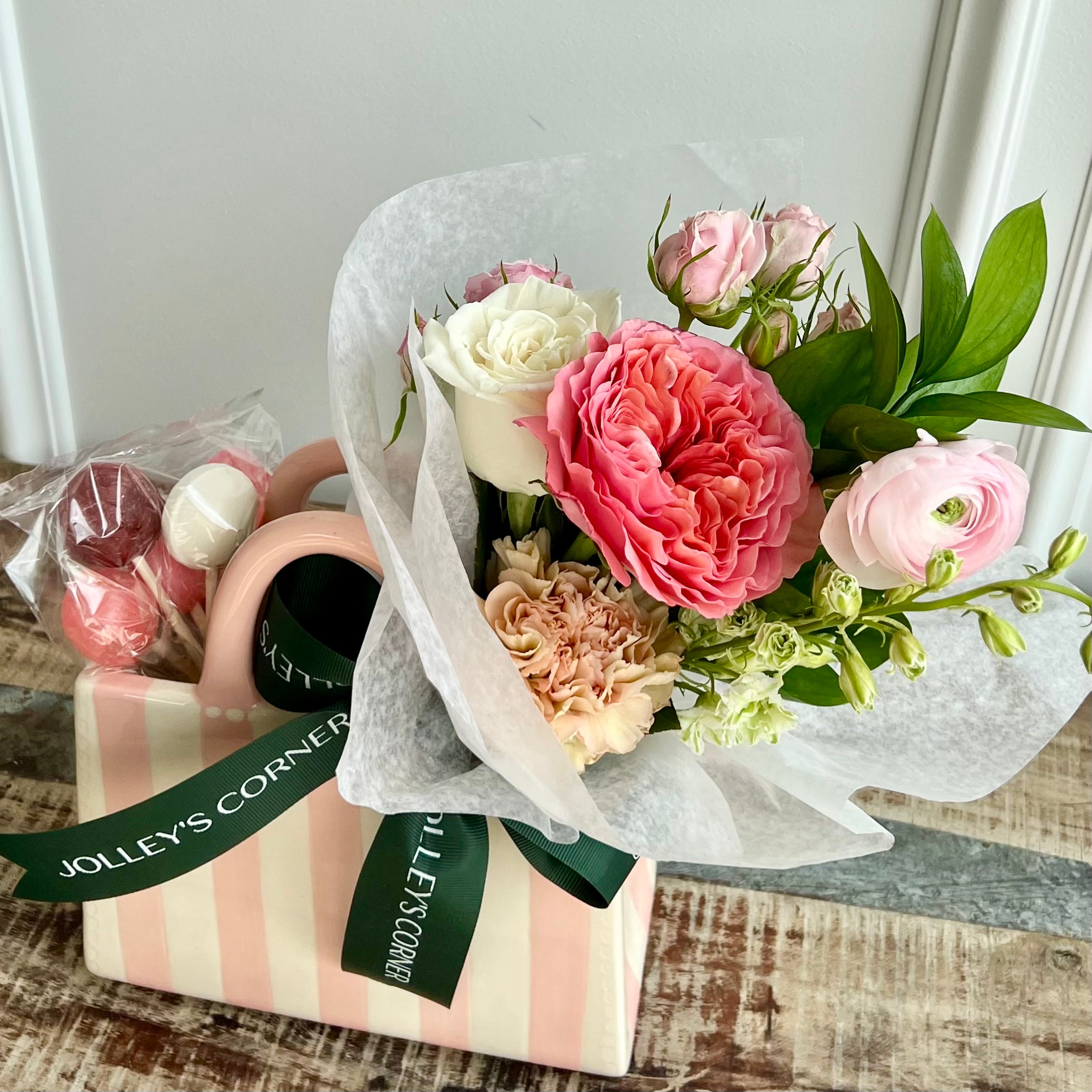 Product shoot of floral arrangement in a glass decor bag with lollipops. 