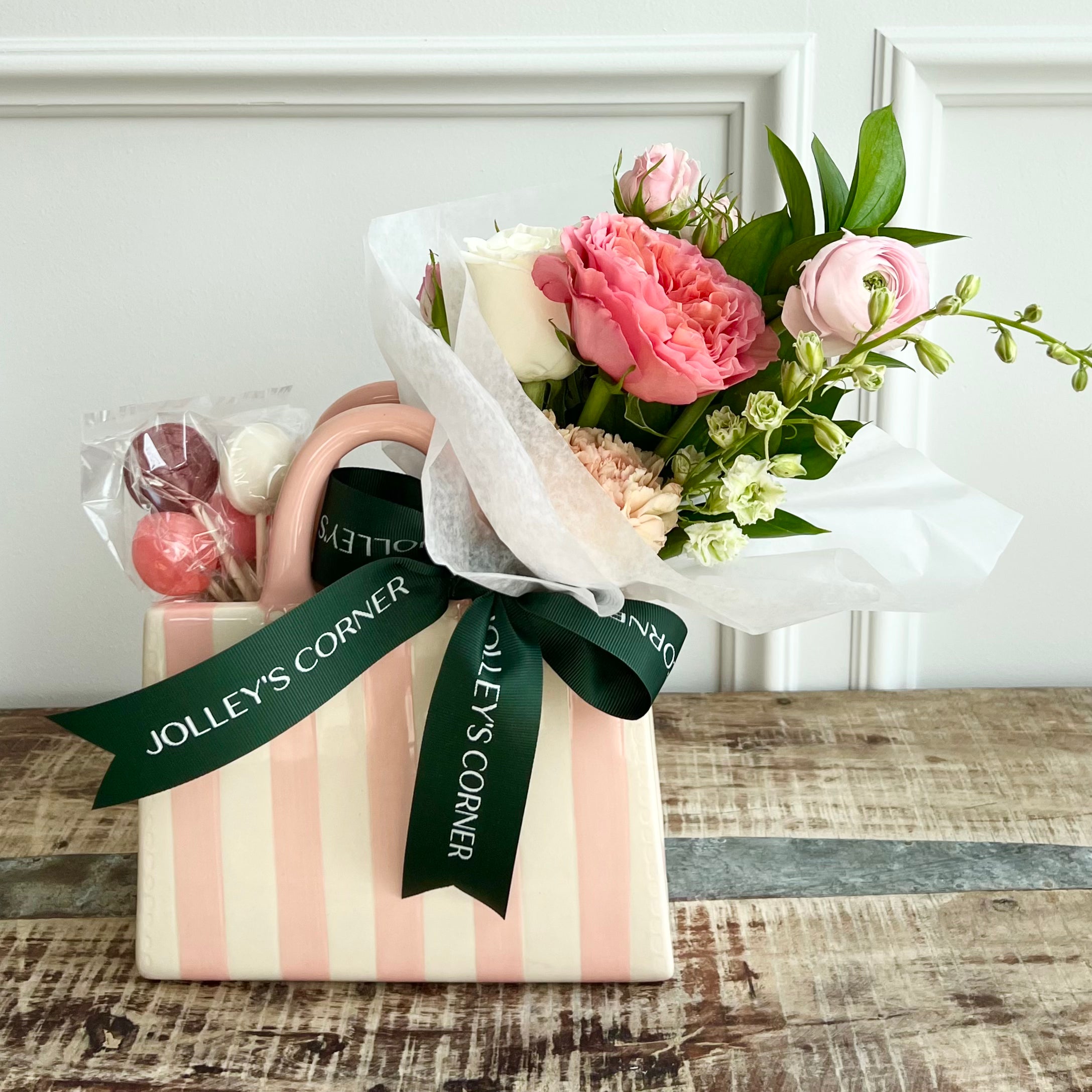Product shoot of floral arrangement in a glass decor bag with lollipops. 