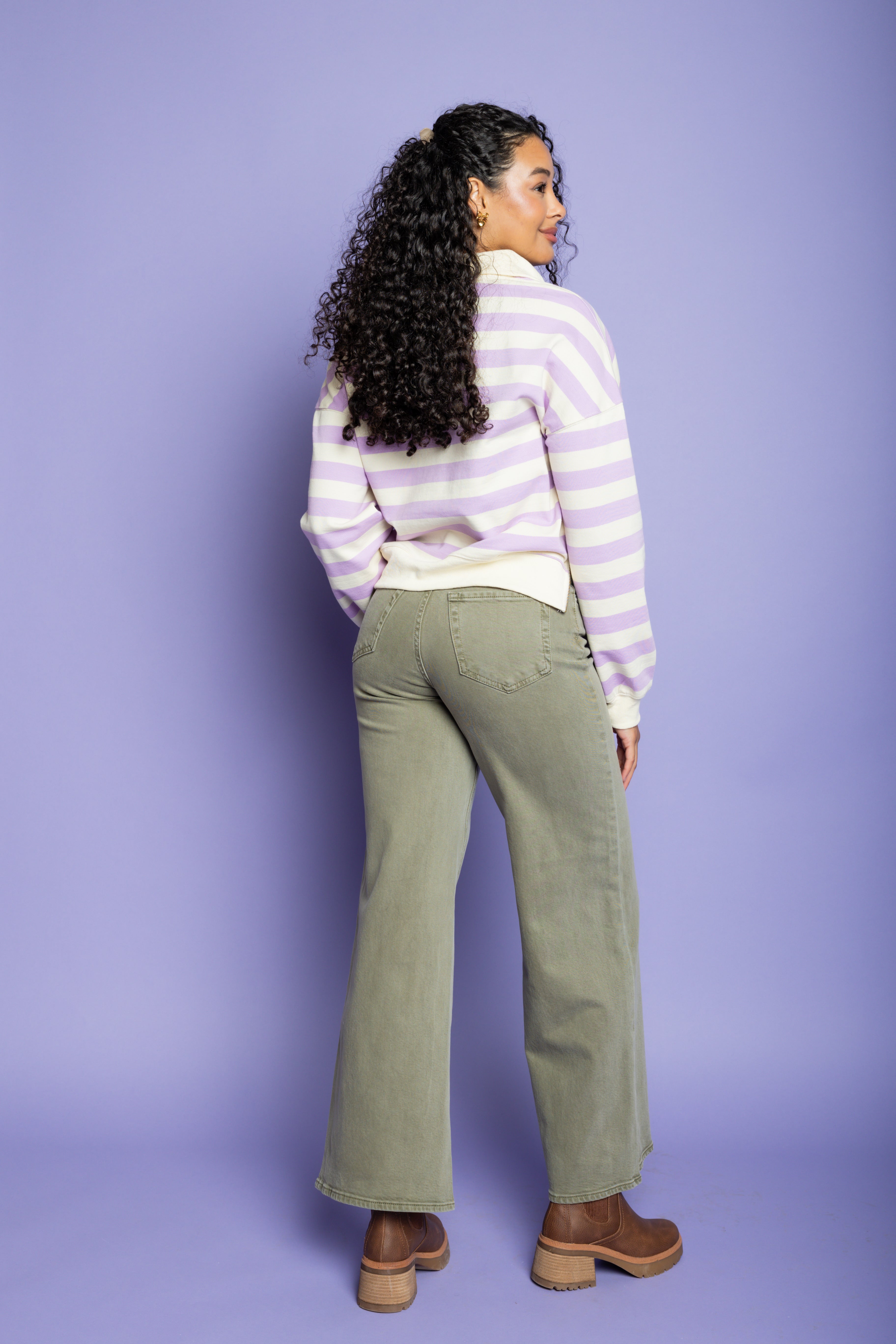 Model is wearing a purple striped top with green wide-leg pant