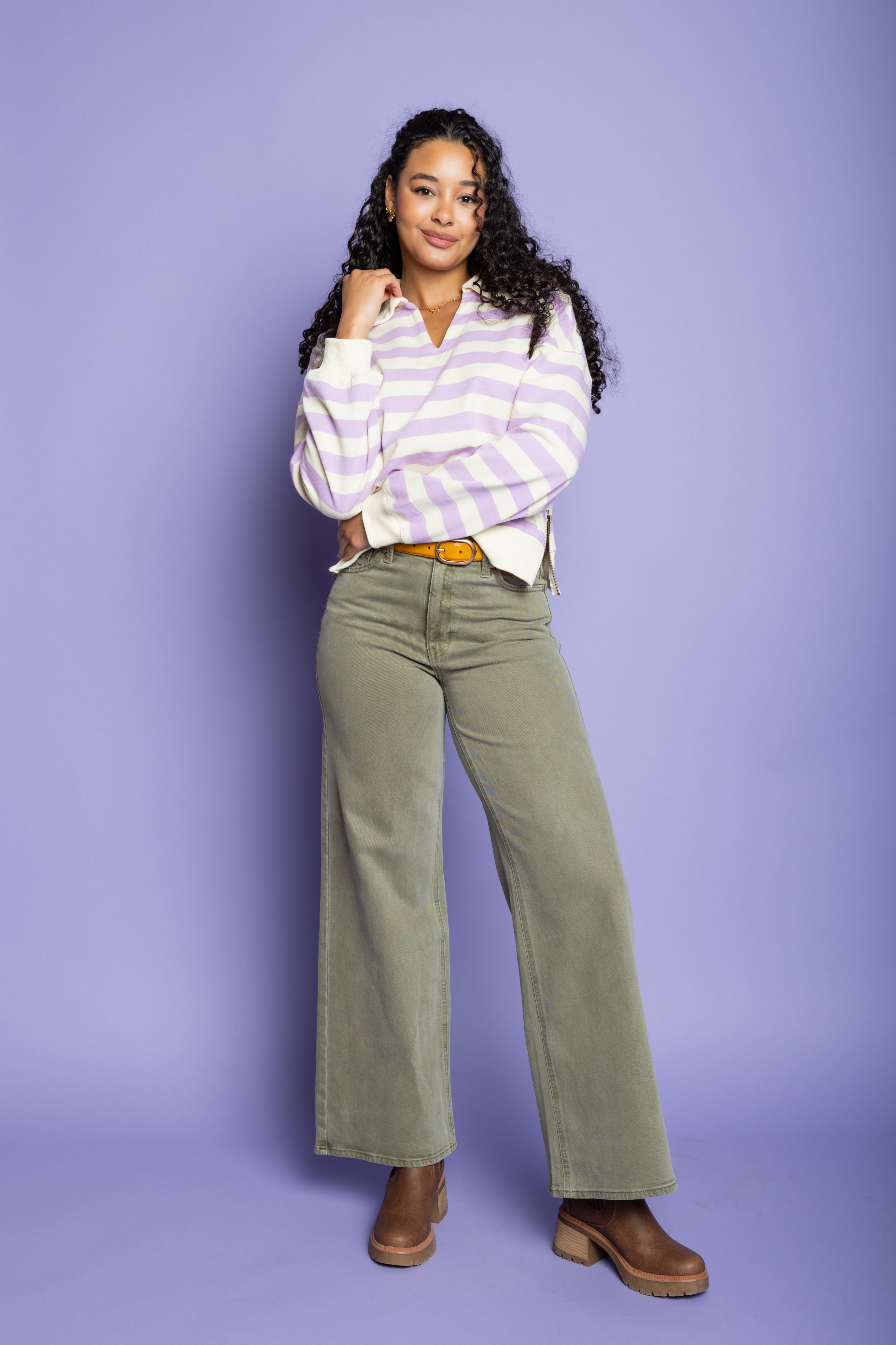 Model is wearing a purple striped top with green wide-leg pant