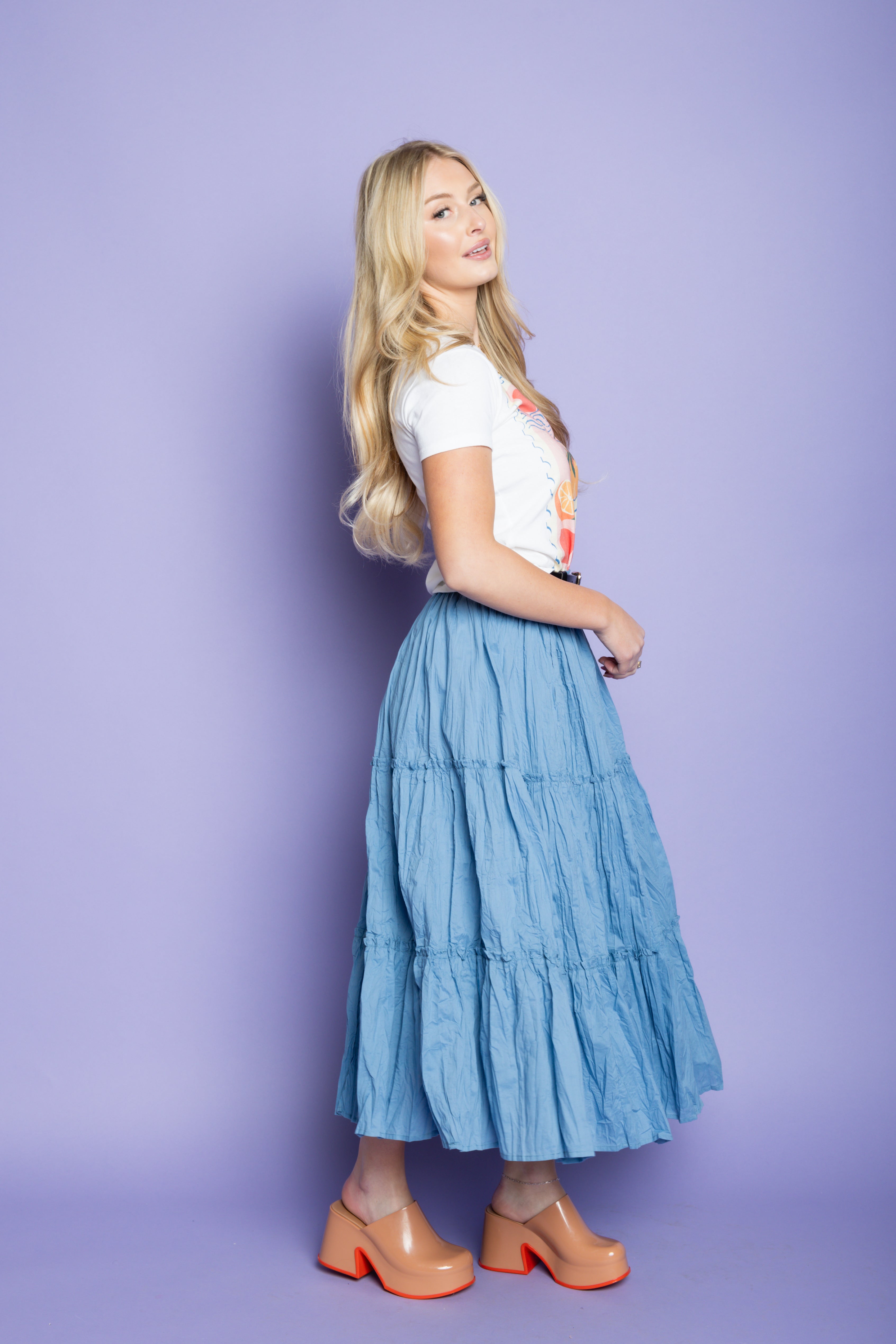 Model wearing an Italian t-shirt and flowy tiered maxi skirt. 