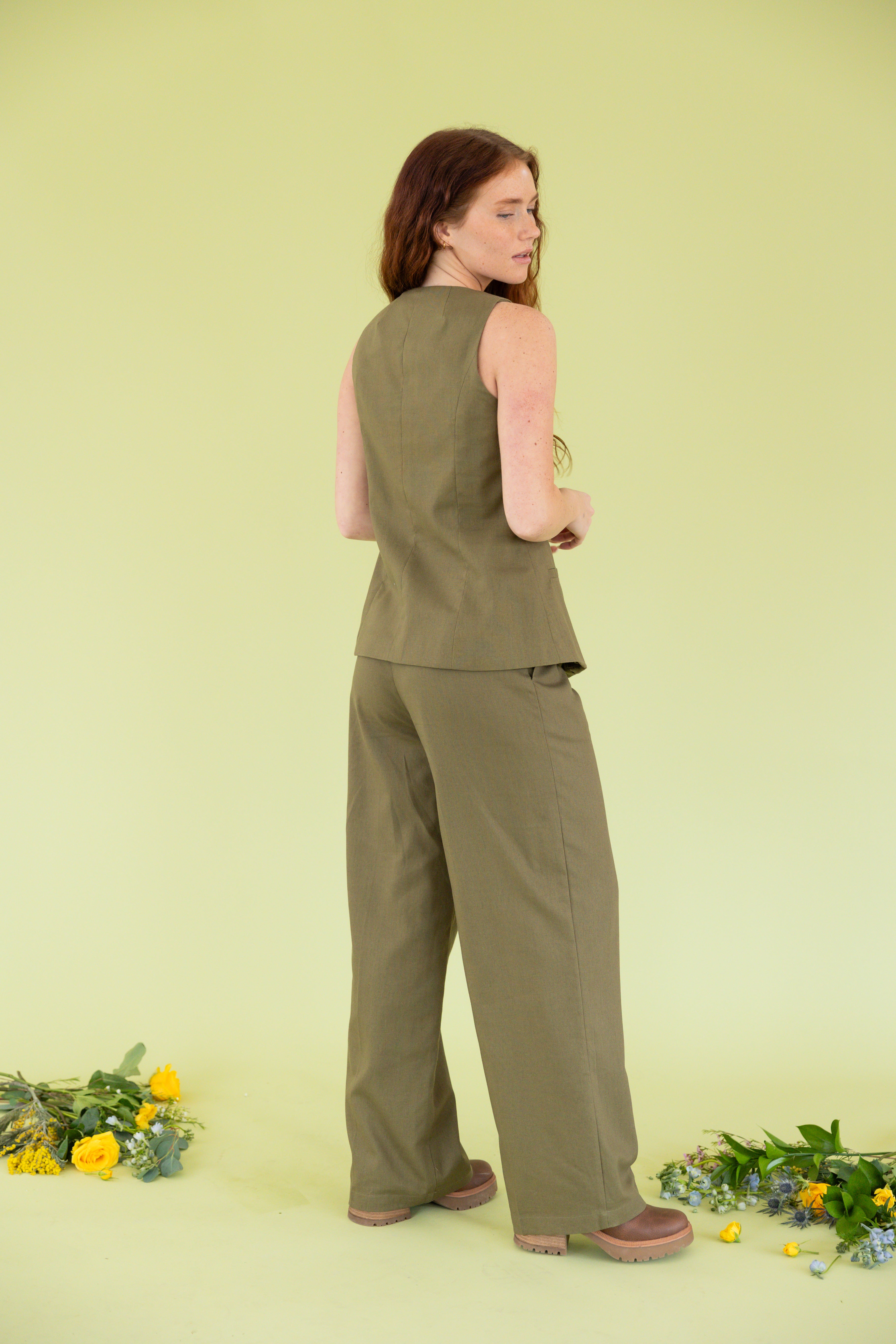 Model is wearing green business casual slacks. 