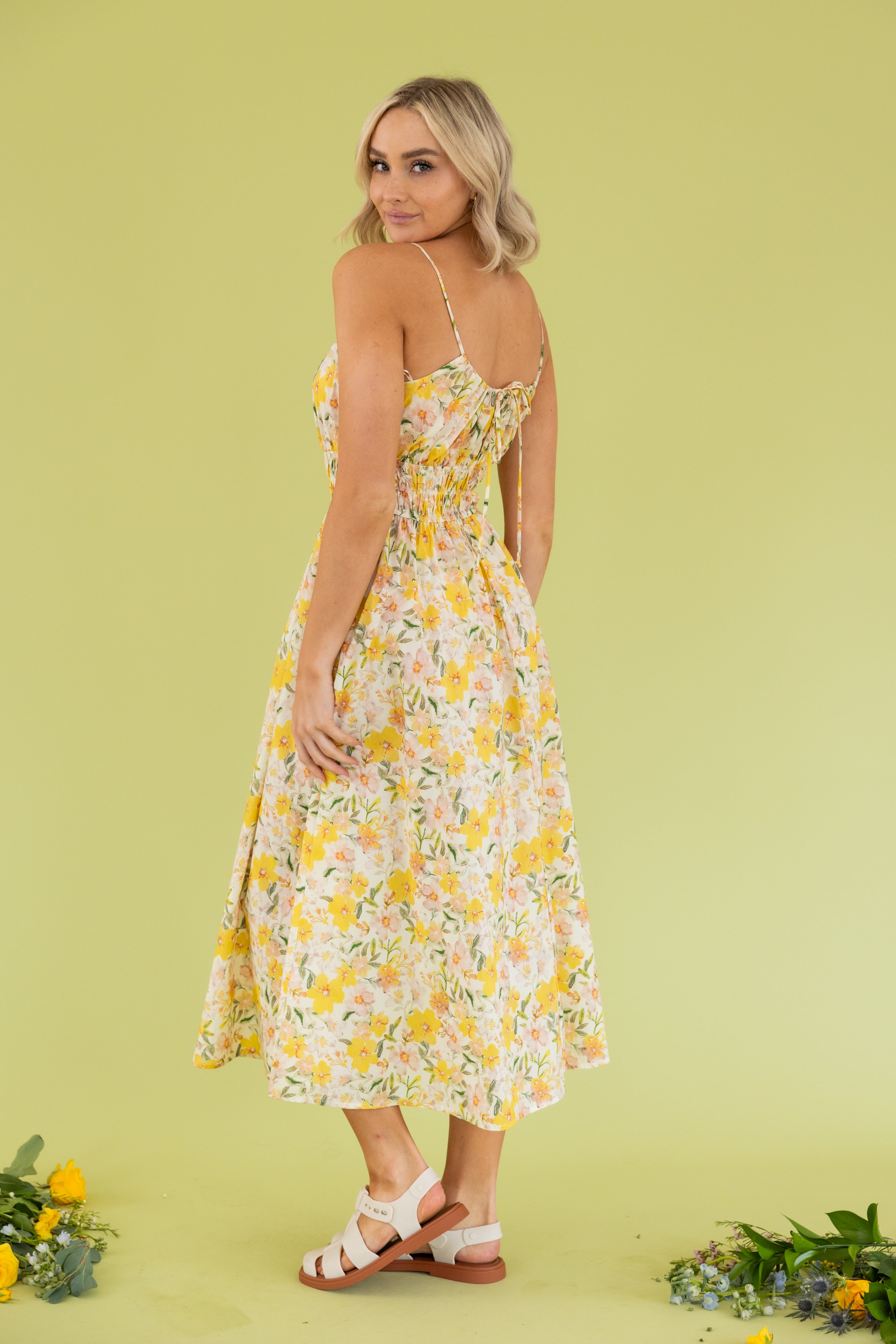 Model is wearing a floral halter maxi dress.