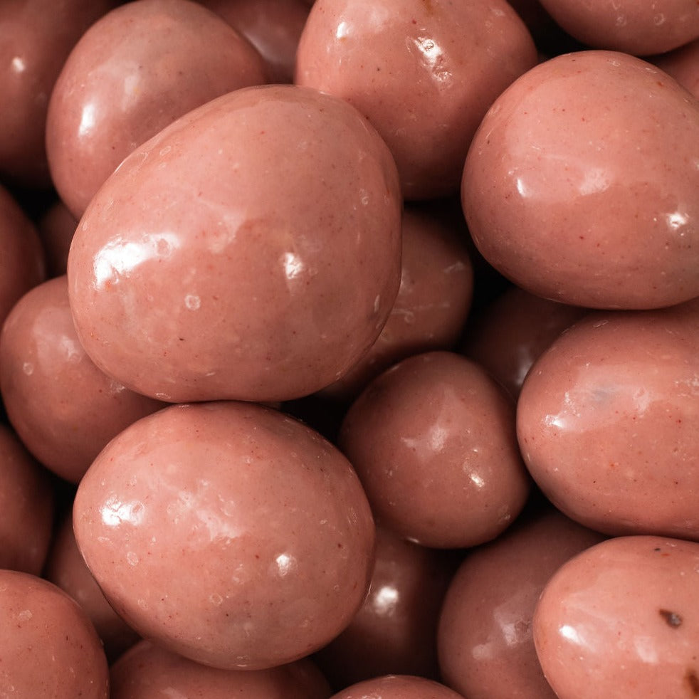 Chocolate pink strawberries coming out of a scoop